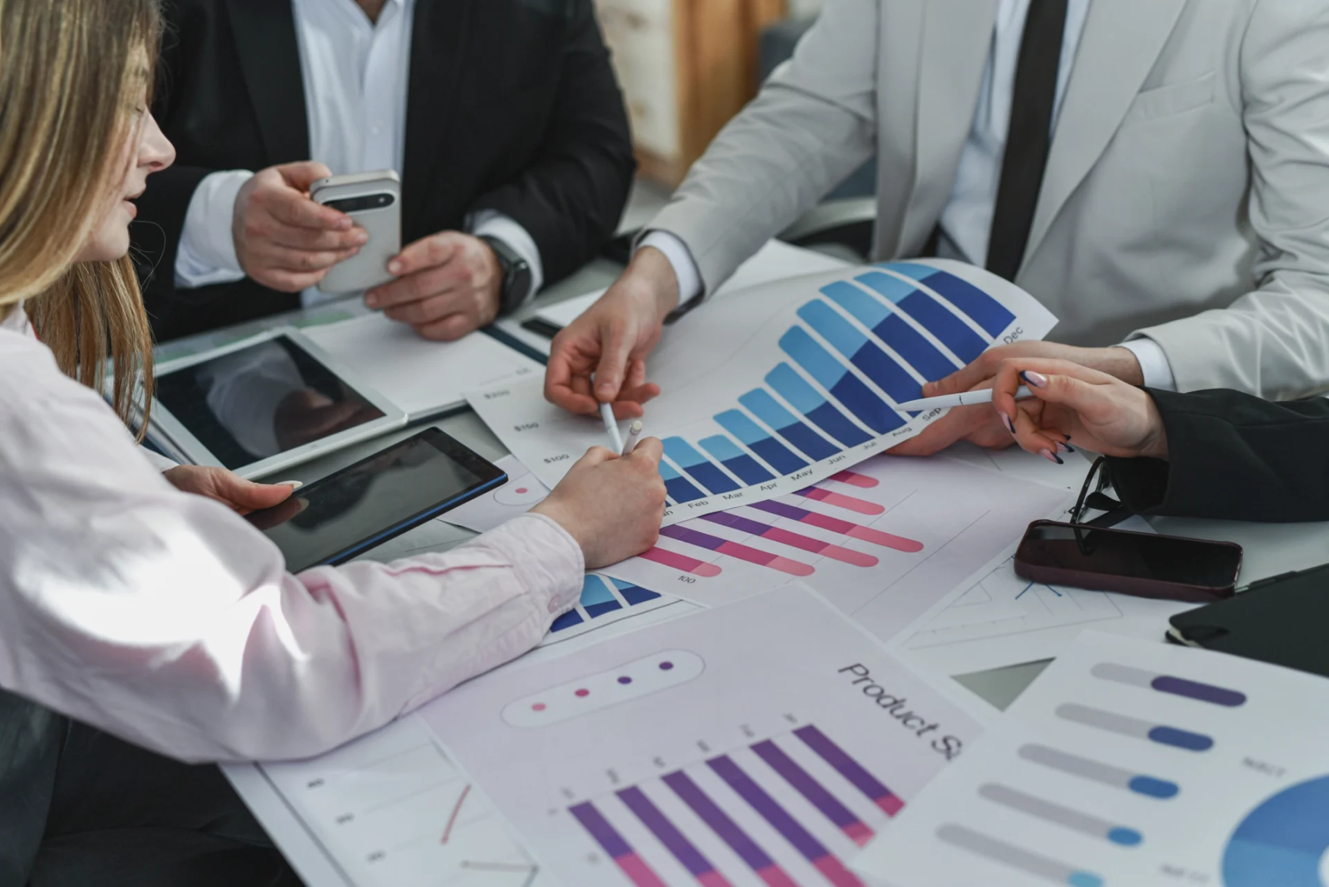 People analyzing business graphs and charts.