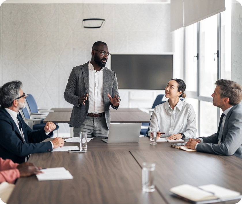 Business meeting with diverse professionals discussing strategy.